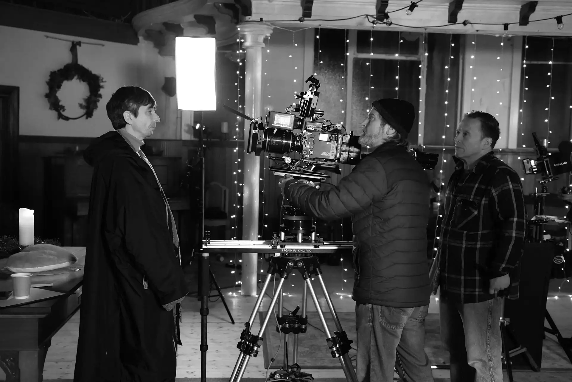 two men setting the camera up for filming.