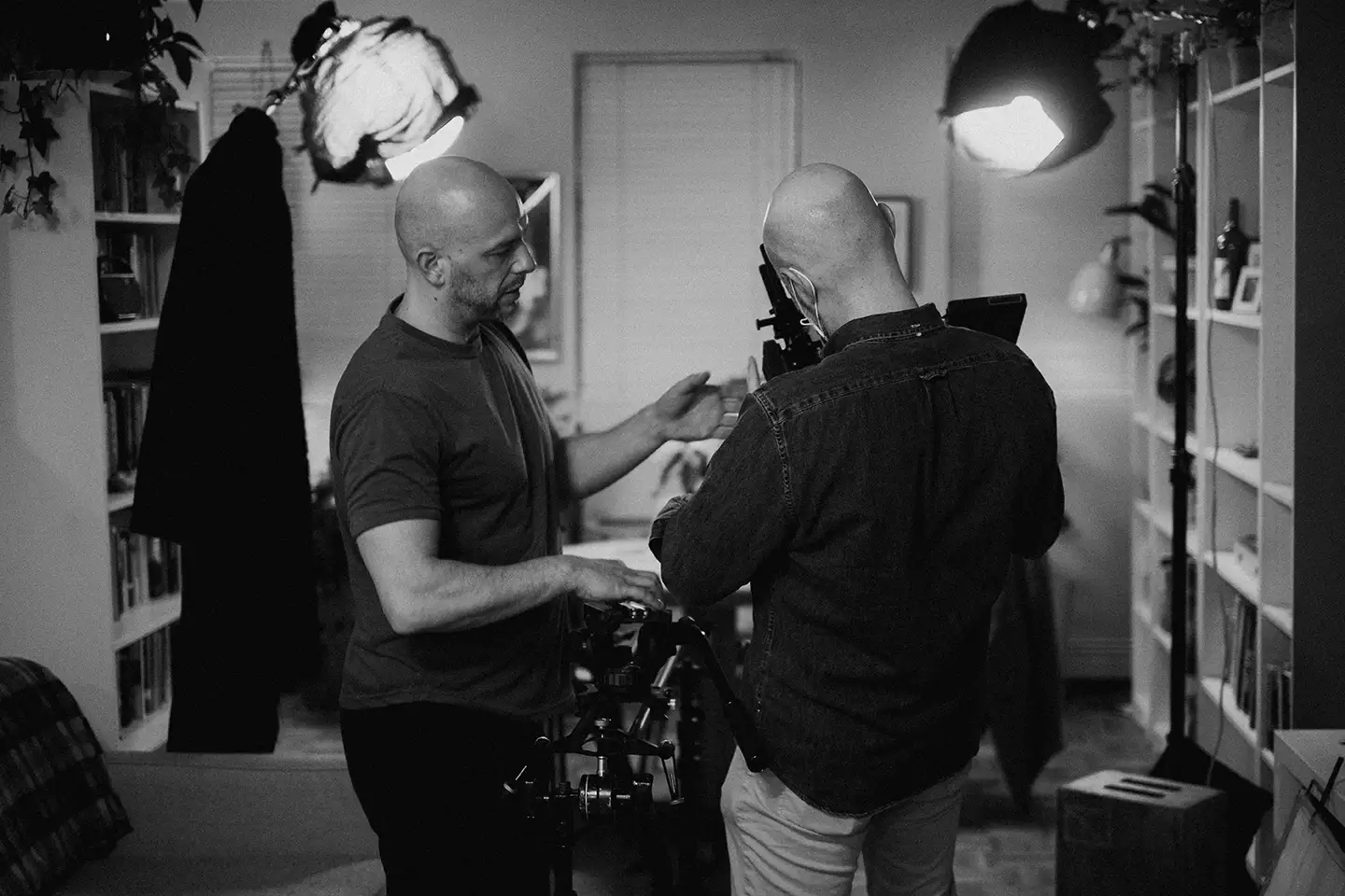 film set interior, two men setting the camera up for filming.