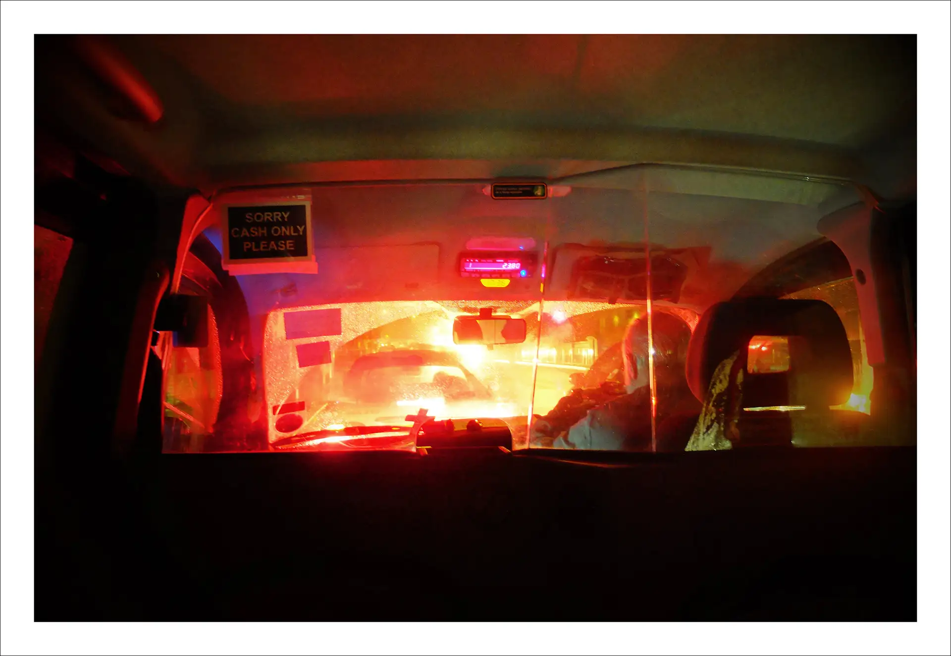London, from the back seat of a black taxi at night