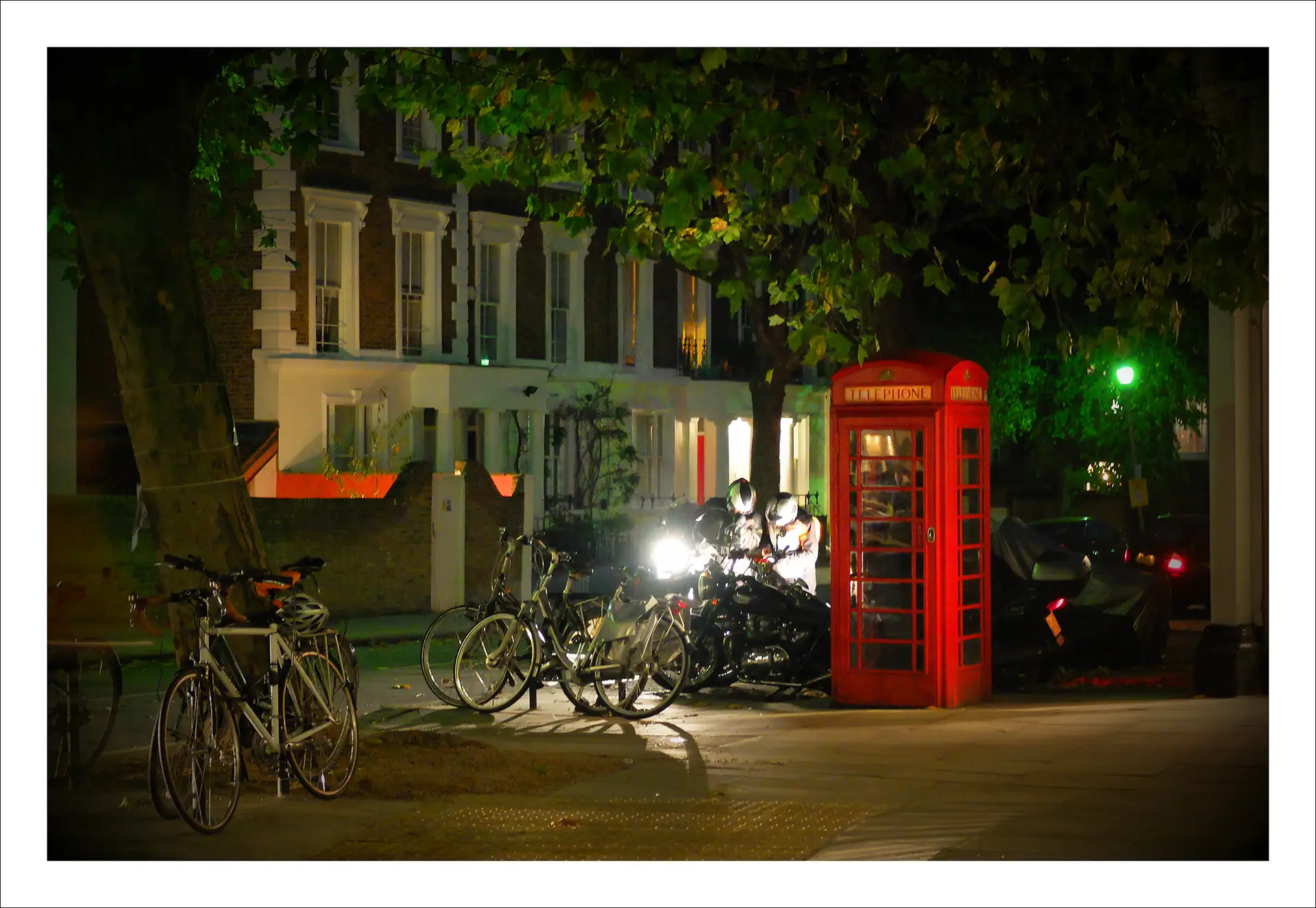 London, bicycles beside a red telephone box at night
