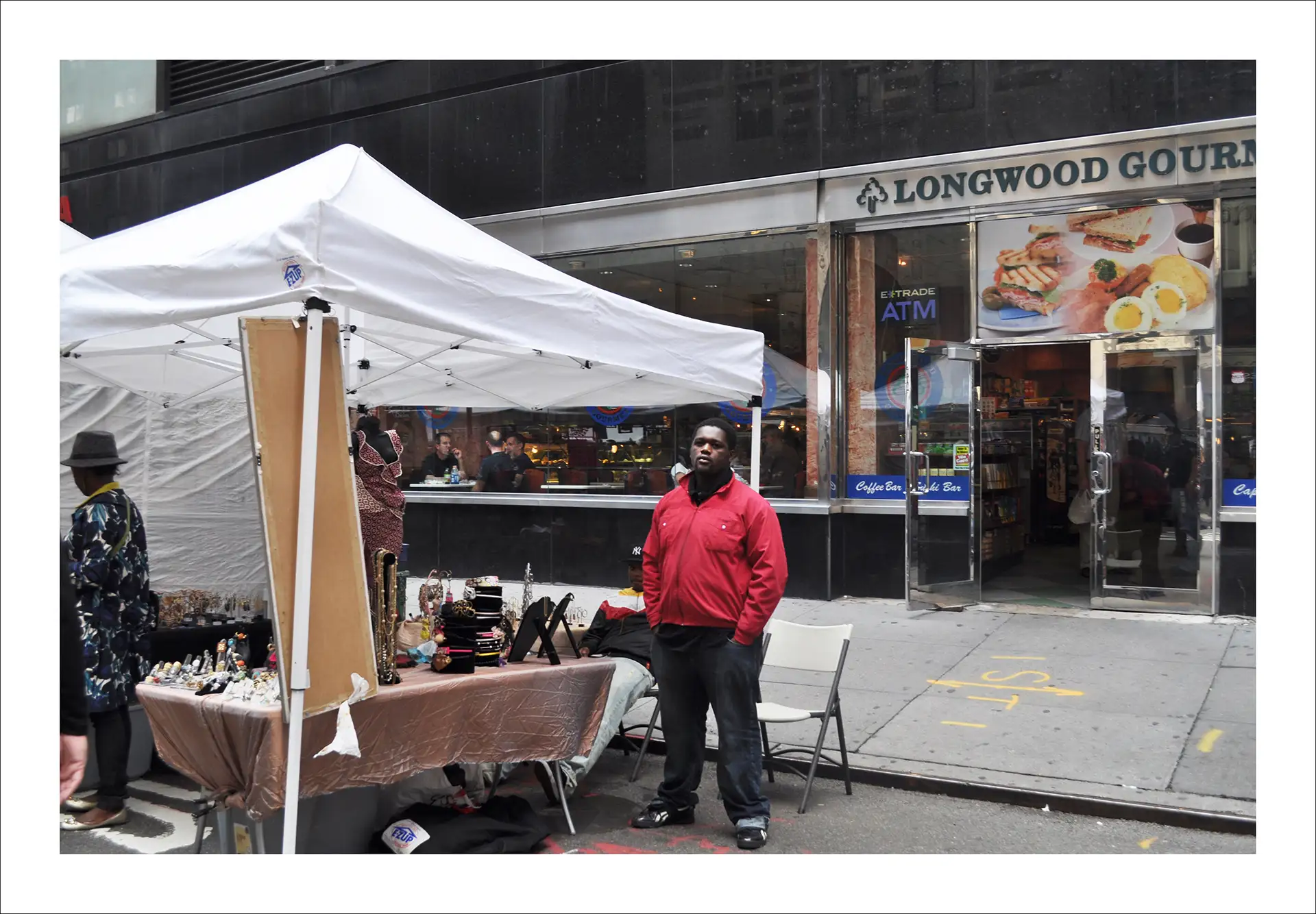 New York, man standing beside a market stall